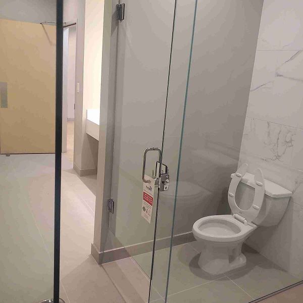 A shower door in the simple bathroom area
