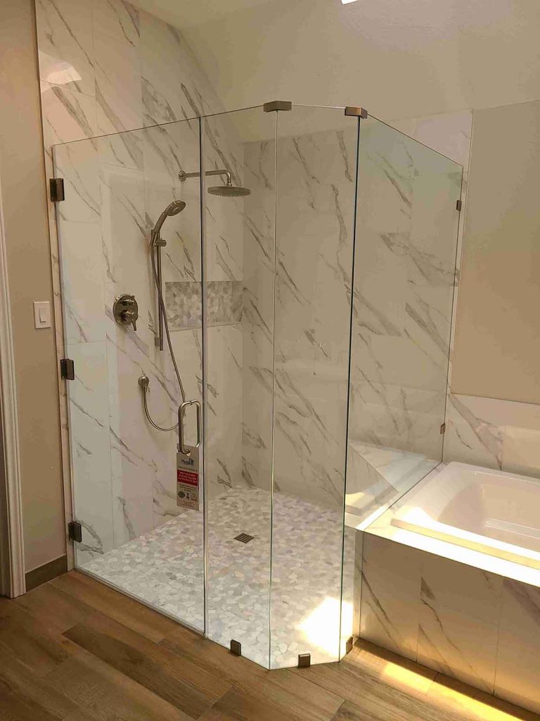 A cornered shower area with glass door