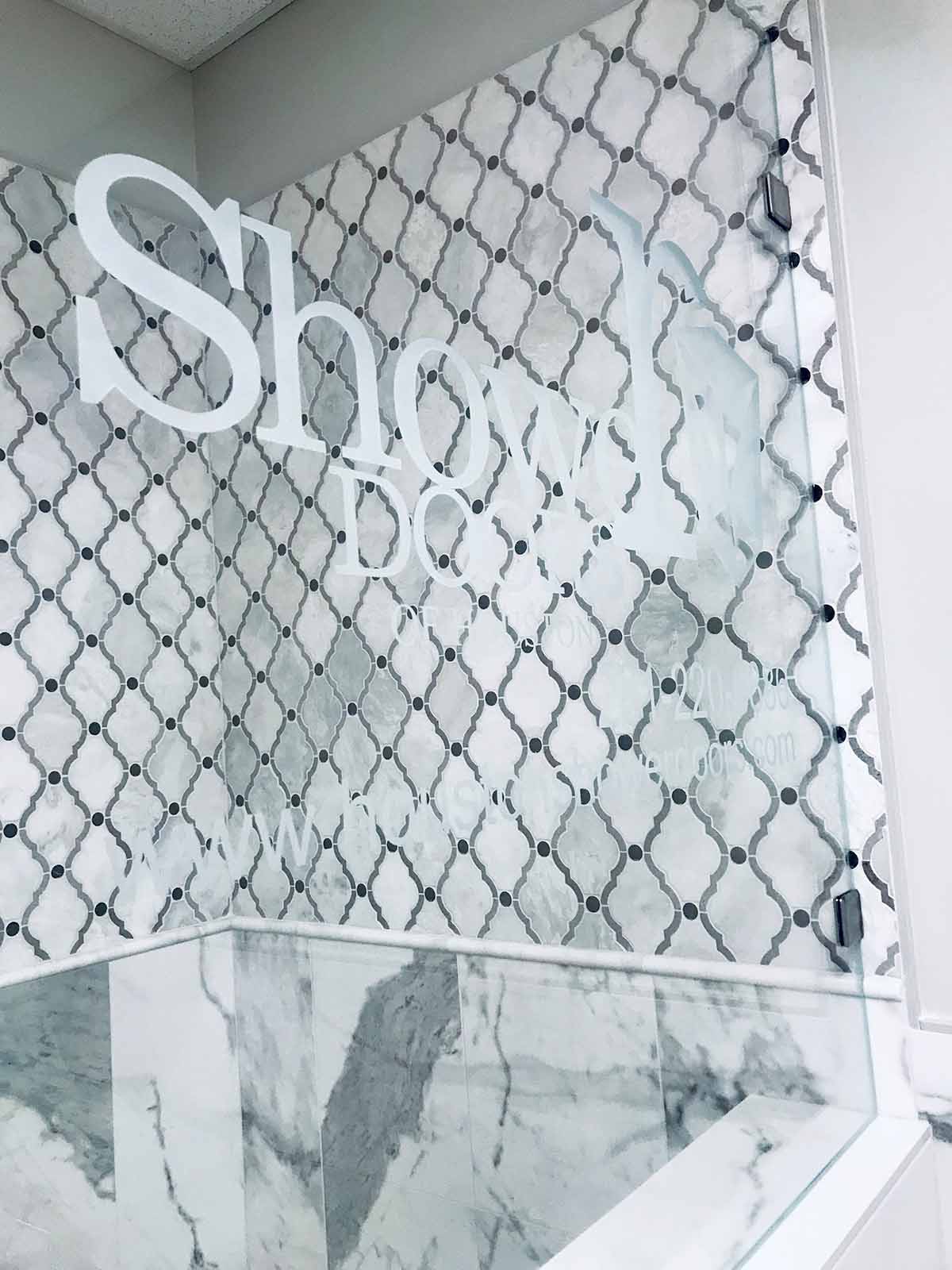 A glass door with logo shower doors of houston