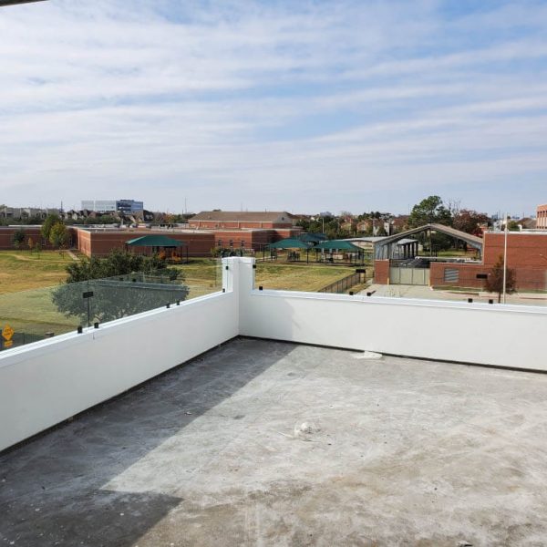 A balcony area with a glass rail