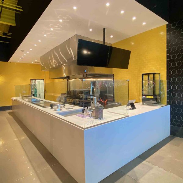 A sneezeguard installed in the food counter